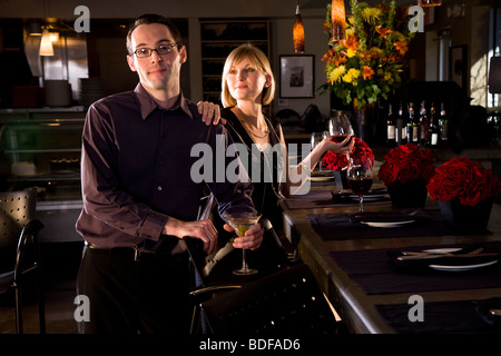 Young couple with drinks at restaurant Stock Photo