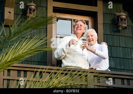 Affectionate senior couple on balcony of home Stock Photo