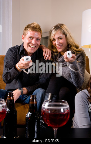 Young couple playing video game in living room Stock Photo