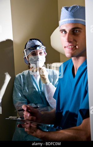 Portrait of two healthcare workers in scrubs with clipboard Stock Photo