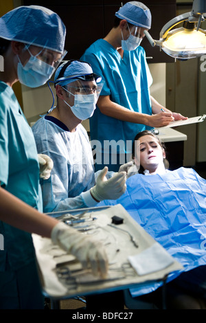 Portrait of dentist and assistants working on patient Stock Photo