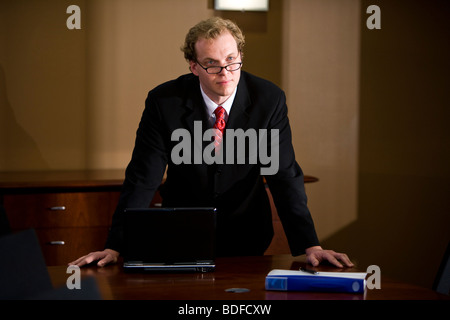 Mid-adult businessman in office boardroom Stock Photo