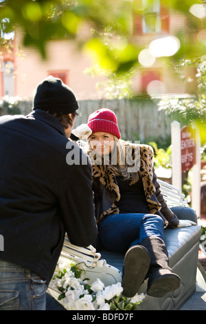 Young stylish couple sitting in horse drawn carriage Stock Photo