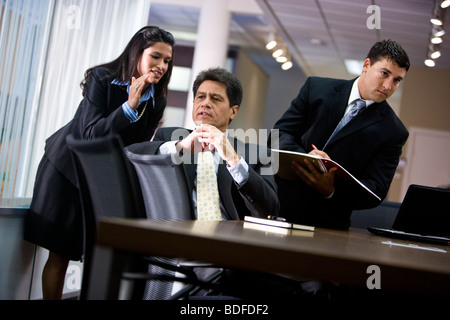 Hispanic businesspeople in office meeting Stock Photo