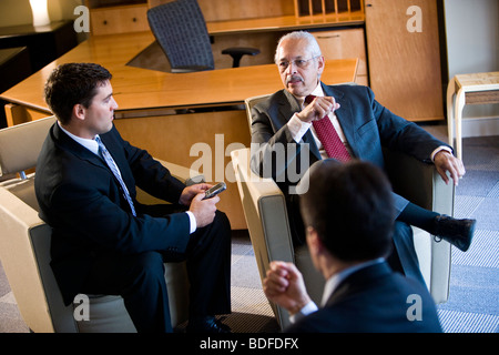 High angle view of Hispanic businessmen talking in office Stock Photo