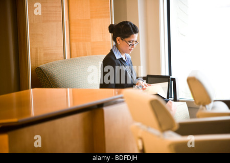 Hispanic businesswoman working in office Stock Photo
