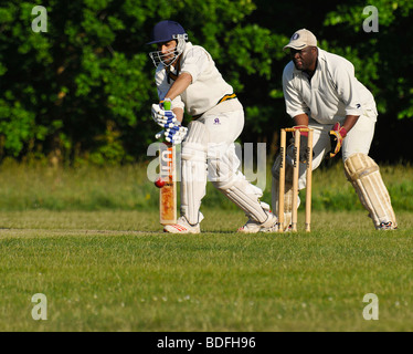 Batsman hitting ball with defensive block Stock Photo