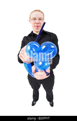 young magic tinkering a balloon animal with balloons Stock Photo