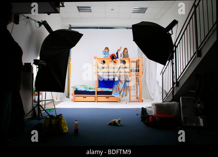 children playing in a Billi-Bolli loft bed in a photo studio Stock Photo