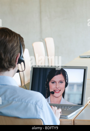 Businessman video calling colleague Stock Photo