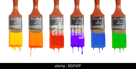 Brushes with paint of different colors dripping Stock Photo