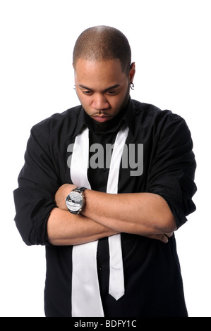 Young African American businessman with arms crossed looking down Stock Photo