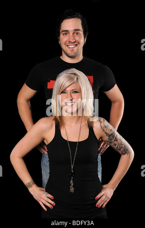 Portrait of man and woman smiling isolated over black background