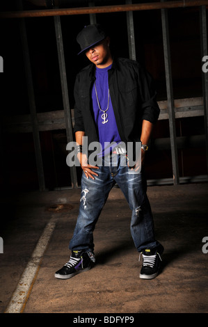 African American hip hop dancer standing over industrial background Stock Photo