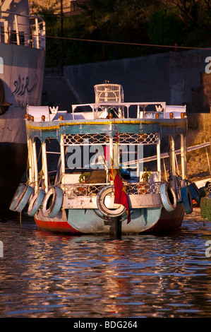 Aswan small colorful passenger ferry boat Nile River Aswan Egypt traditional transport vessel Stock Photo