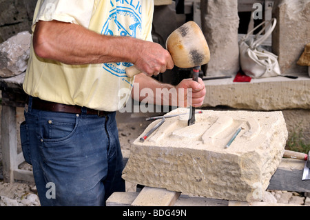 Sculptor working on a stone Stock Photo