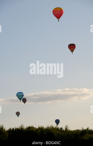 Stock photo of 6 hot air balloons rising up in the evening sky. Stock Photo