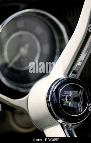Wolfsburg's coat of arms on the steering wheel of an old VW Beetle, in the back the speedometer, Germany Stock Photo