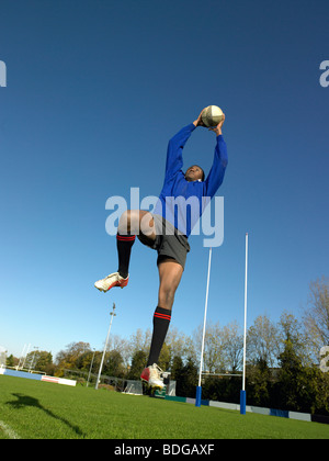 One Man, Rugby Player Catching Ball In Jump Isolated On White ...