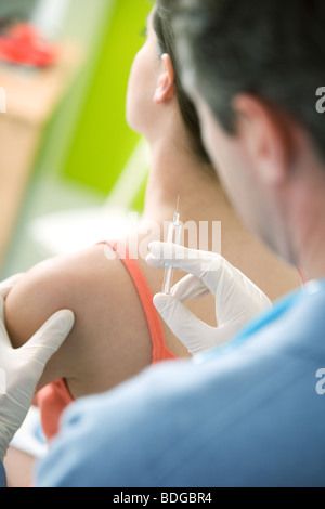 VACCINATING A WOMAN Stock Photo