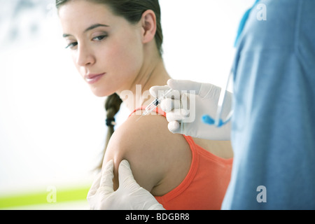 VACCINATING A WOMAN Stock Photo