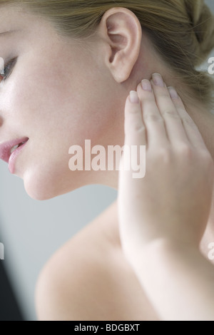 WOMAN PALPATING LYMPH NODE Stock Photo