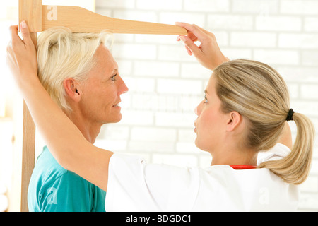 MEASURING HEIGHT, ELDERLY PERSON Stock Photo