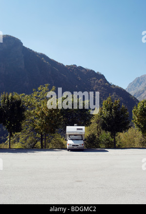 motor home parked in front of a beautiful mountain range. Stock Photo