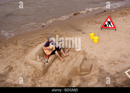 Sand sculptor busking on the Thames south bank Stock Photo