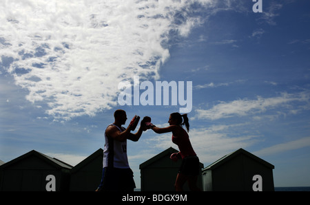 Couple keep fit boxing together on Hove Lawns Brighton UK Stock Photo