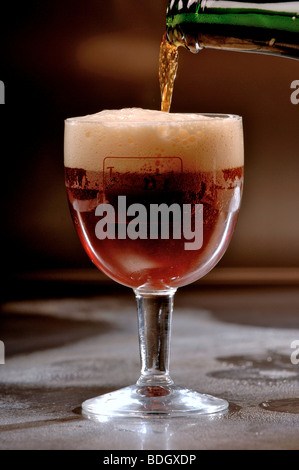 Pouring glass of Achel Belgian Trappist beer. Stock Photo