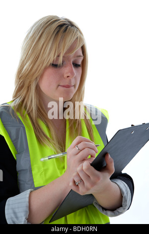 young 20 year old blonde woman wearing high vis vest reading notes she has taken on a clipboard Stock Photo
