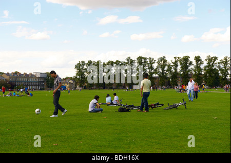 Playing football Parkers Piece Cambridge Cambridgeshire England UK Stock Photo