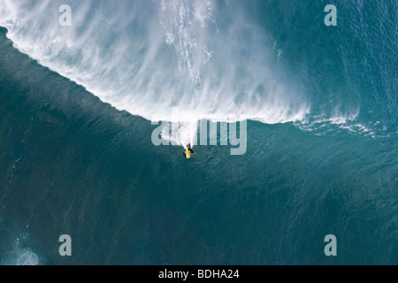 An aerial view of a young man body boarding on a huge wave at Pipeline on the North Shore of Oahu, Hawaii. Stock Photo