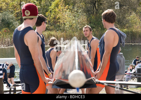 Members of the men's crew team at Hobart College carry their 8 man shell down to the water at the Hobart Crew Regatta. Stock Photo