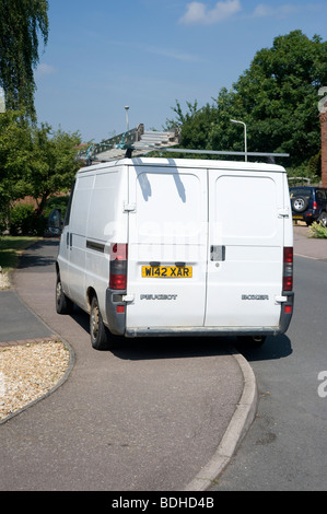 White peugeot box van parked on the pavement on a suburban street in England Stock Photo