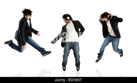 Young modern man dancing over a white background Stock Photo