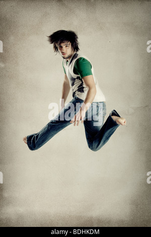 Young modern man jumping over grunge background Stock Photo