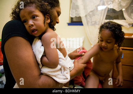 Selena Pina, a homeless mother of four, gets her children dressed for school at the Family Promises Center in Sacramento, CA. Stock Photo
