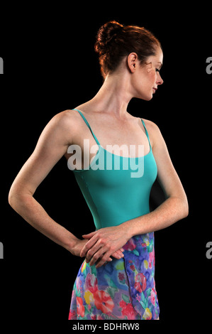 Beautiful ballerina with hands on hips isolated over a black background Stock Photo