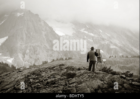 An artist paints the view of Mt. Shuksan and the glacier at the end of the Mt. Baker Highway in northwest Washington State. Stock Photo