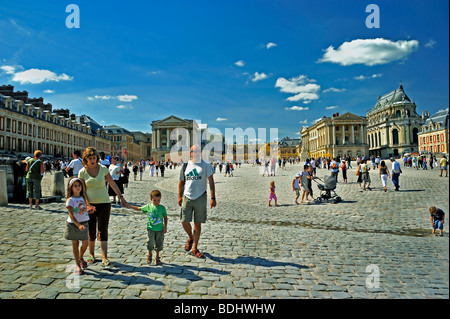 Versailles Palace - Tourist Family Visiting French Monument, 'Chateau de Versailles', Walking in Courtyard, front of French chateau, historic holidays Stock Photo