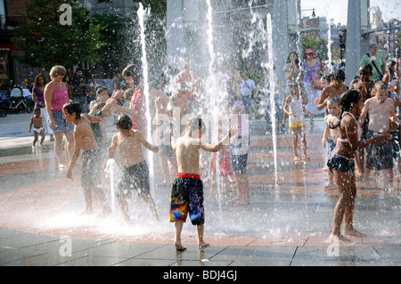 Kids playing in fountain on a hot day, Boston, Massachusetts, USA Stock Photo