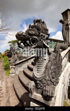 Indonesia, Bali, Tirta Gangga, Water Palace garden, dragon motif bridge over south pond to demon island Stock Photo