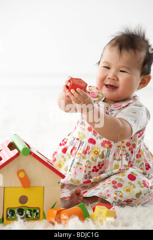 Girl Playing with Shapes and House Stock Photo