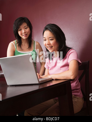 Two Women Using Laptop Computer