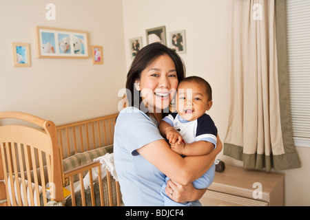 Mother Holding Baby Boy Stock Photo