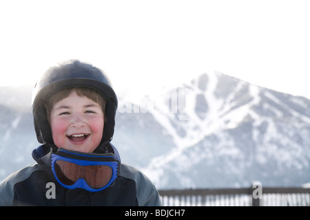 Little Boy Wearing Helmet and Ski Goggles, Mount Baldy in the Background, Sun Valley, Idaho, USA Stock Photo
