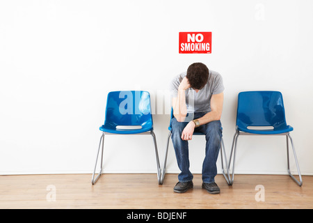 Man Sitting in Waiting Room Stock Photo