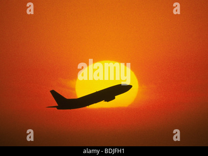 Boeing 737 Jetliner Taking Off, Sunset Silhouette Stock Photo